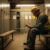Industrial worker writing notes in a locker room after shift.